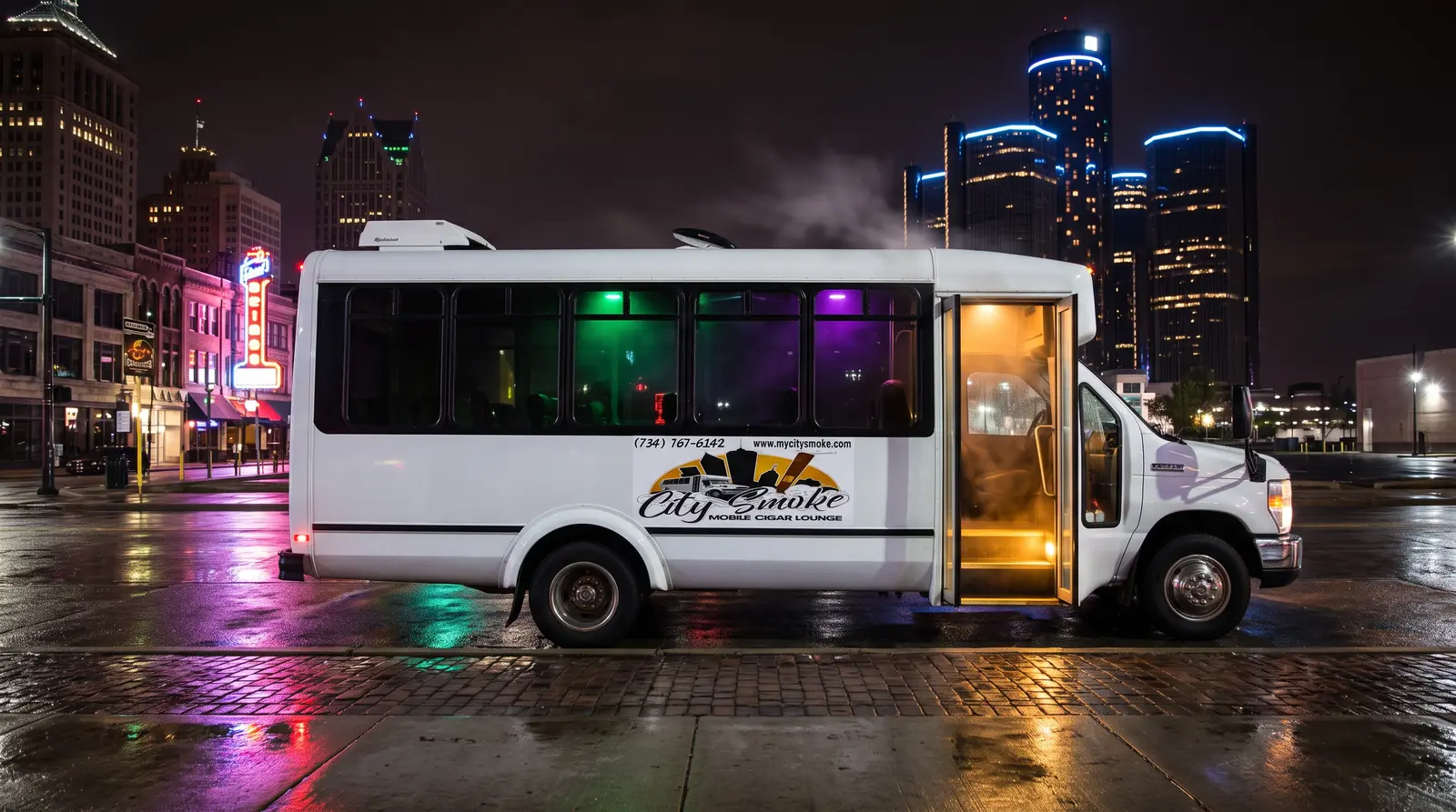 The City Smoke bus cruising downtown Detroit at night
